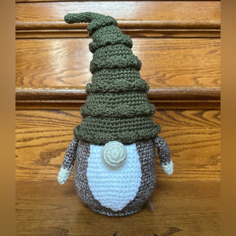 Handmade Crochet Gnome Christmas tree hate, with grey/brown body.